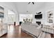 Bright living room with hardwood floors, fireplace, and views to sunroom at 1003 Jervey Point Rd, Wando, SC 29492