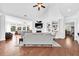Bright living room featuring hardwood floors, a fireplace, built-in shelves, and comfortable seating at 1003 Jervey Point Rd, Wando, SC 29492