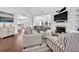 Spacious living room with hardwood floors, a fireplace, and views into the kitchen at 1003 Jervey Point Rd, Wando, SC 29492
