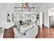 Open-concept living room with soaring ceiling and built-in shelving, seamlessly blending with dining area at 1003 Jervey Point Rd, Wando, SC 29492