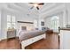 Spacious main bedroom with tray ceilings, shuttered windows, hardwood floors and sitting area at 1003 Jervey Point Rd, Wando, SC 29492