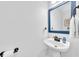 Stylish powder room with pedestal sink, decorative mirror, and classic fixtures at 1003 Jervey Point Rd, Wando, SC 29492