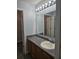Modern bathroom features granite countertops, a framed mirror, and updated lighting at 103 Dupont Way, Summerville, SC 29485
