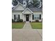 Charming front door features a simple porch, green grass, bushes, and black shutters at 103 Dupont Way, Summerville, SC 29485