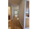 Hallway with hardwood floors leads to a bright living space and bathroom at 103 Dupont Way, Summerville, SC 29485