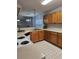 Another view of the kitchen featuring wooden cabinetry, white appliances, and tile flooring at 103 Dupont Way, Summerville, SC 29485