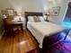Comfortable bedroom features a wood sleigh bed, hardwood floors, and a colorful rug at 104 Silverhill Rd, Walterboro, SC 29488