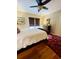 Comfortable bedroom features a wood sleigh bed, hardwood floors, and window blinds at 104 Silverhill Rd, Walterboro, SC 29488