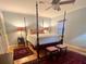 Spacious bedroom featuring hardwood floors, ceiling fan, and a four-poster bed at 104 Silverhill Rd, Walterboro, SC 29488