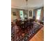 Dining area featuring a wood table, chandelier, rug, and built-in china cabinet at 104 Silverhill Rd, Walterboro, SC 29488
