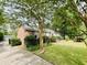 Well-manicured front lawn with lush landscaping leading to a classic brick home at 104 Silverhill Rd, Walterboro, SC 29488