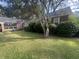 Brick house featuring a screened-in porch and established shrubbery for a private and inviting curb appeal at 104 Silverhill Rd, Walterboro, SC 29488