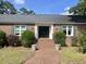 Classic brick home with an inviting brick walkway and manicured shrubs leading to a double door entryway at 104 Silverhill Rd, Walterboro, SC 29488