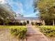 Charming single-story brick home with mature trees and a brick pathway to the front door at 104 Silverhill Rd, Walterboro, SC 29488