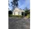 Detached garage with covered area, framed by lush greenery, offering extra storage and parking space at 104 Silverhill Rd, Walterboro, SC 29488