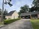 Exterior shot featuring a detached garage and covered parking, set amidst well-maintained greenery and landscaping at 104 Silverhill Rd, Walterboro, SC 29488