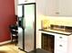 Kitchen featuring a stainless steel refrigerator, white cabinets, and black countertops at 104 Silverhill Rd, Walterboro, SC 29488