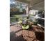 Charming screened patio with brick floor, glass-topped table and decorative wrought iron chairs at 104 Silverhill Rd, Walterboro, SC 29488
