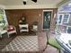 Inviting screened porch with brick floor features ample seating and charming decor at 104 Silverhill Rd, Walterboro, SC 29488