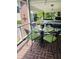 Screened porch featuring brick floors, a glass table, and wrought iron chairs at 104 Silverhill Rd, Walterboro, SC 29488