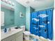 Charming bathroom with bright blue walls, whale-themed shower curtain, and well-lit vanity area at 108 Spanish Oaks Ln, Ladson, SC 29456