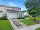 Townhouse front exterior features lush landscaping, a garage and neutral siding at 108 Spanish Oaks Ln, Ladson, SC 29456