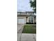 Townhouse front exterior features lush landscaping, a garage and neutral siding at 108 Spanish Oaks Ln, Ladson, SC 29456