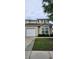 Townhouse front exterior features lush landscaping, a garage and neutral siding at 108 Spanish Oaks Ln, Ladson, SC 29456