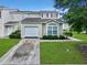 Townhouse front exterior features lush landscaping, a garage and neutral siding at 108 Spanish Oaks Ln, Ladson, SC 29456