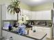 Functional kitchen featuring white cabinetry, light green walls, and essential appliances for modern living at 108 Spanish Oaks Ln, Ladson, SC 29456