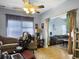 Open living area with mixed furnishings, wood flooring, and a glimpse into an adjacent room at 108 Spanish Oaks Ln, Ladson, SC 29456