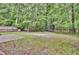 Spacious backyard featuring mature trees, a trampoline, and play equipment for outdoor fun at 110 Instructor Ct, Ladson, SC 29456