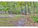 Large backyard surrounded by lush greenery with a trampoline and play area for  at 110 Instructor Ct, Ladson, SC 29456