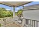 Relaxing outdoor balcony with white railing overlooking a peaceful, treed neighborhood at 110 Instructor Ct, Ladson, SC 29456