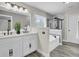 Elegant bathroom featuring double sinks, soaking tub with tile surround, and glass shower at 110 Instructor Ct, Ladson, SC 29456