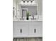 Bathroom vanity with double sinks, decorative millwork, and contrasting dark hardware at 110 Instructor Ct, Ladson, SC 29456