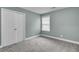 Cozy bedroom with neutral carpeting, ample closet space, and natural light at 110 Instructor Ct, Ladson, SC 29456