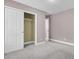Carpeted bedroom with neutral walls and a closet with sliding doors at 110 Instructor Ct, Ladson, SC 29456