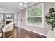 Bright dining area featuring hardwood floors, large windows, stylish lighting, and backyard views at 110 Instructor Ct, Ladson, SC 29456