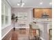 Bright dining area featuring hardwood floors, large windows, stylish lighting, and counter seating at 110 Instructor Ct, Ladson, SC 29456