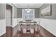 A charming dining room featuring hardwood floors, a chandelier, and white wainscoting at 110 Instructor Ct, Ladson, SC 29456