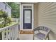 Inviting front porch featuring a 'Welcome' mat and gray chair, offering a warm greeting at 110 Instructor Ct, Ladson, SC 29456
