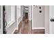 Bright hallway with glossy wood floors leading to a living space with a fireplace at 110 Instructor Ct, Ladson, SC 29456