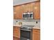 Well-lit kitchen featuring stainless steel appliances, tile backsplash, and granite countertops at 110 Instructor Ct, Ladson, SC 29456