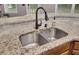 Close up of double kitchen sink with black faucet, granite countertop, and subway tile backsplash at 110 Instructor Ct, Ladson, SC 29456