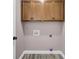 Laundry room with hardwood floors, overhead cabinets and utility hookups at 110 Instructor Ct, Ladson, SC 29456