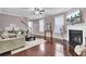 Bright living room features a fireplace, hardwood floors, comfortable seating, and a modern aesthetic at 110 Instructor Ct, Ladson, SC 29456