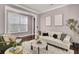 Bright and airy living room with large windows, a modern sofa, and tasteful decor at 110 Instructor Ct, Ladson, SC 29456