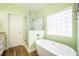 Bright bathroom features a modern tub and glass-enclosed shower at 116 Holbrook Ln, Goose Creek, SC 29445