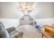 Bonus room with a gray armchair, piano, and natural light at 116 Holbrook Ln, Goose Creek, SC 29445